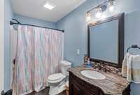 Hall bathroom features tub/ shower combo