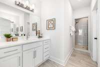 The primary ensuite is outfitted with dual vanities and a glass-door enclosed shower