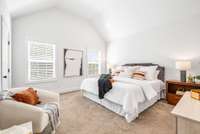 Upstairs, the generous primary suite anchors one end of the home