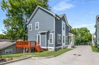 A view here of the back of the home shows the guest parking area between the houses and the back deck for grilling