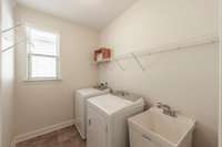 The laundry room is bright and even has a sink!