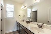 The hall bath has double vanities and a tile shower!