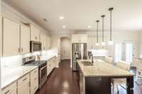 The back hallway leads to the pantry, a half bath and the garage entry.