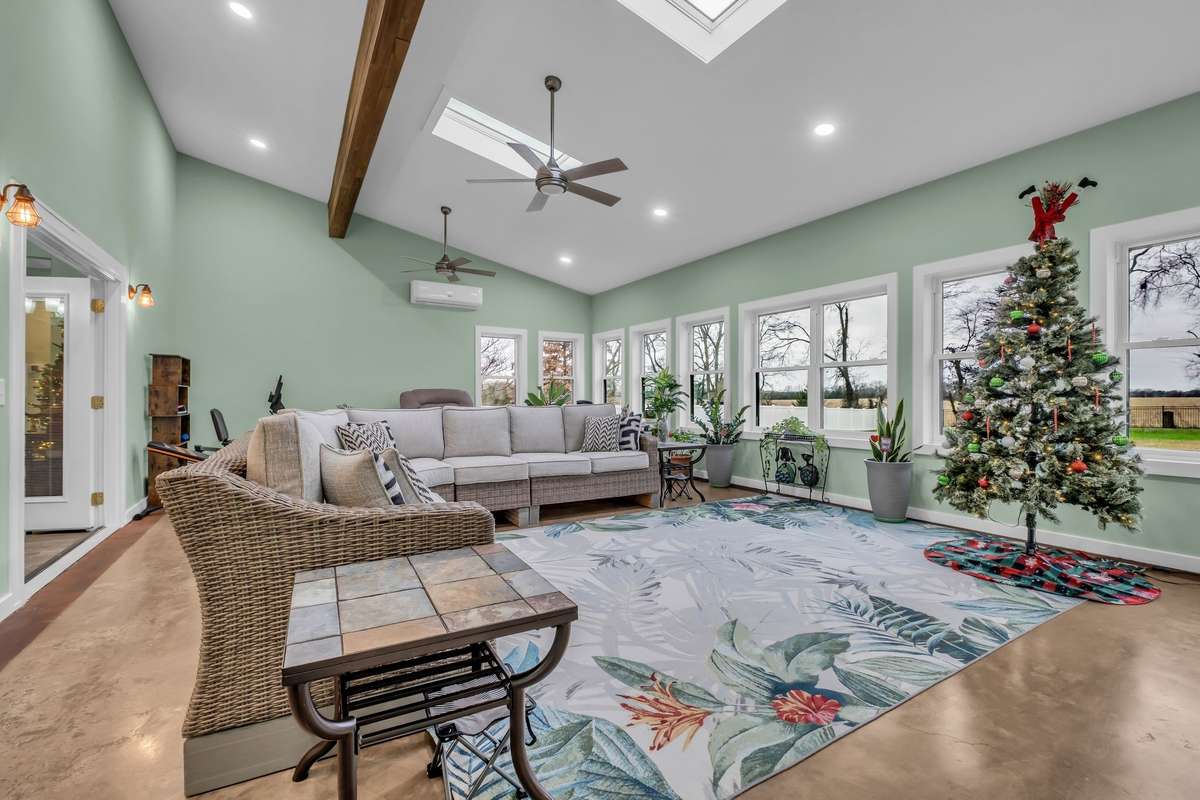 Over 600sf recreation room full of windows overlooking the large, flat backyard.