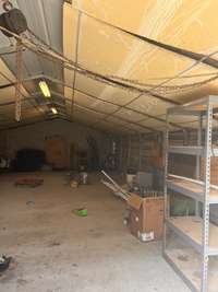 20 x 40 utility building (metal w/ concrete floor) used for lawn equipment, storage.