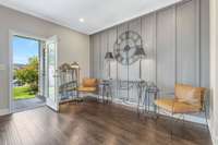 Exit living area on to covered back patio with a ceiling fan