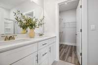 Photo of similar home in the same community. Primary bathroom w/walk-in shower and spacious walk-in closet