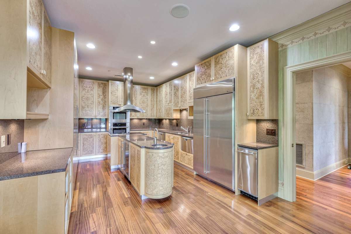 The eat-in kitchen is a culinary lover's dream, with clean lines and Burlwood cabinetry.