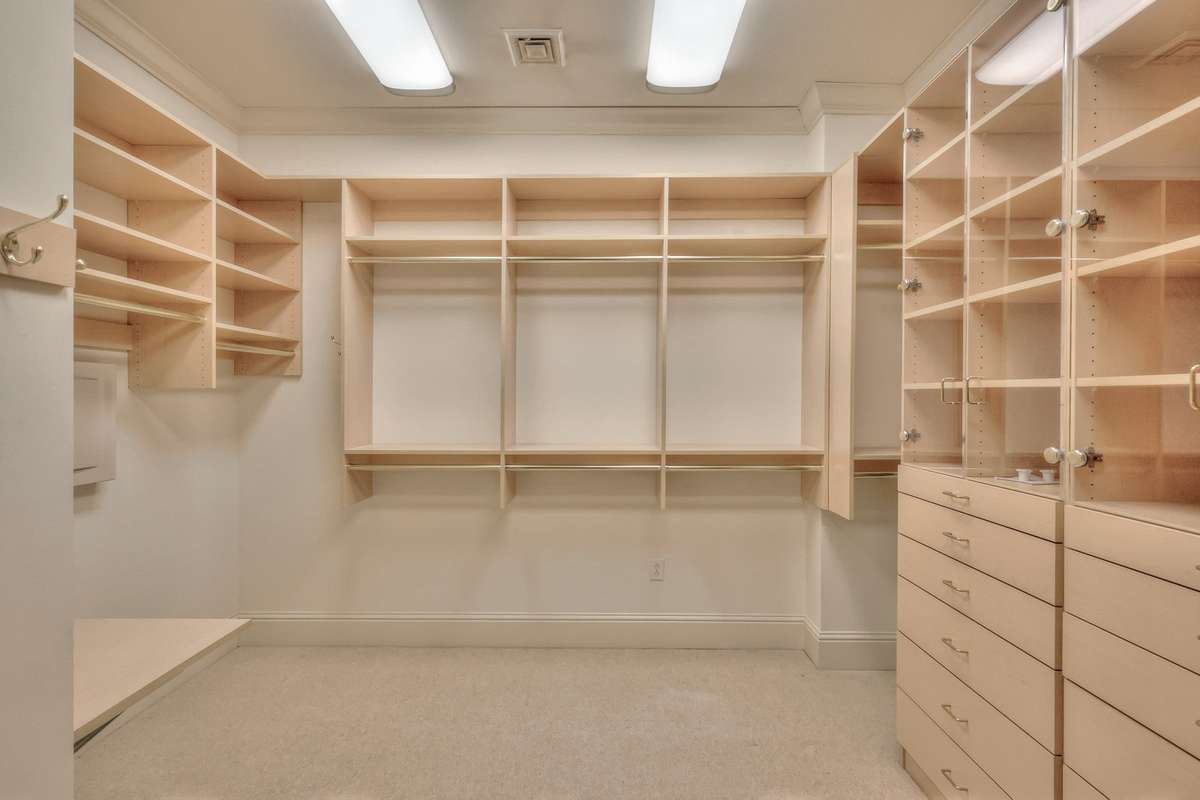 A separate expansive closet with even more built-ins for the primary bedroom.