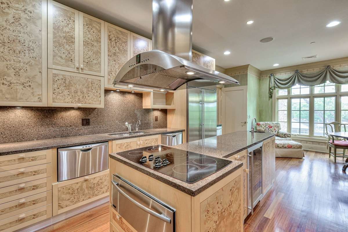 Built for a chef, the high-end range hood is a subtle centerpiece for this space. Pictures taken when home was furnished. Condo is currently unfurnished.