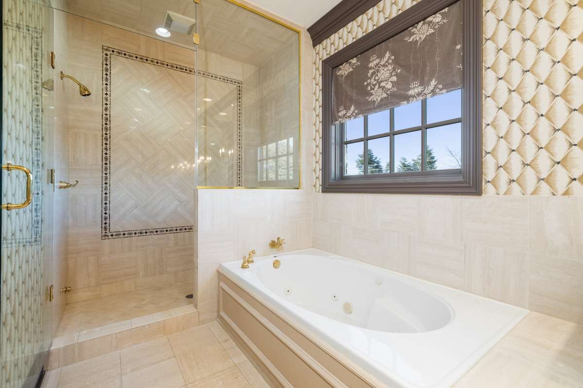 The standing shower and separate soaking bathtub are sure to help you unwind each day.