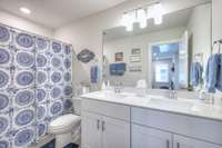 Upstairs hall bathroom includes plenty of storage and double vanities.