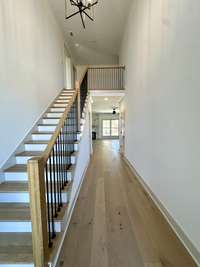 Soaring entry w/wood tread steps.