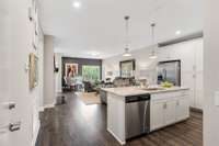 Spacious, light-filled living with upgraded gas fireplace, dining nook, and access to the private balcony with treetop views.