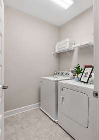 Oversized laundry room comes complete with the clothes washer and dryer providing true move-in readiness.