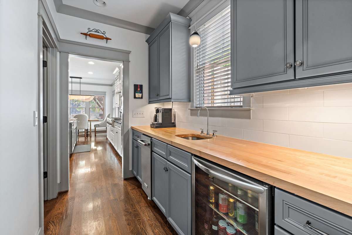 You will love this fantastic Butler's Pantry complete with beverage center, ice maker, bar sink and extra cabinetry. So much storage in this home!