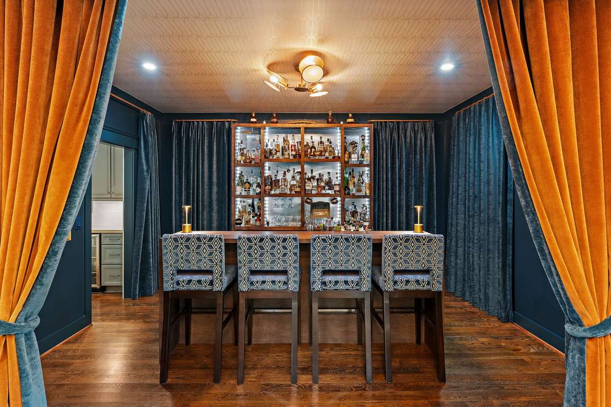 Velvet drapery, custom wall coverings and designer lighting frame the bespoke etagere.