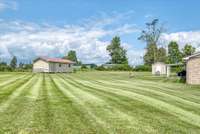 2 STORAGE SHEDS. ONE WITH ELECTRIC