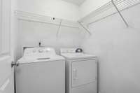 Laundry area with laundry machines included