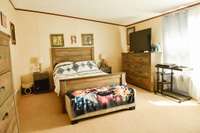 Large primary bedroom fits any size bed you want and so much more