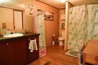 Large primary bathroom with combo soaking tub/shower and oversized walk-in closet