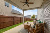 Love the 6ft fence, white lights and covered patio leading to the yard. Room for the kids and dogs to play.