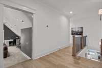 Ascend the stairs to a generous media room that anchors the upper level.