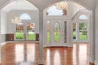 Columns separate your formal dining room, entry and sitting room. Beautiful chandeliers and hardwood flooring accent your home.