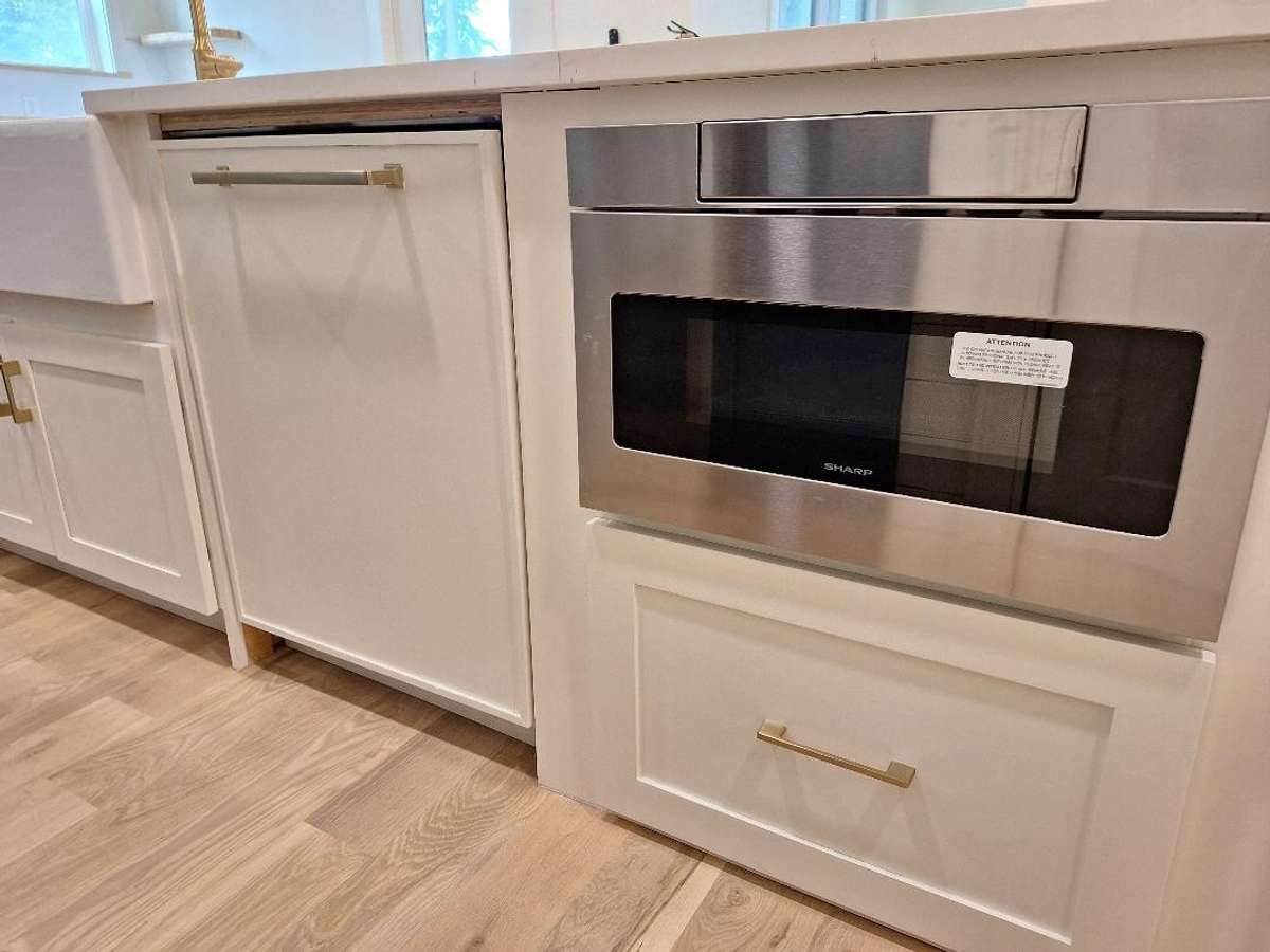 Dishwasher and microwave / warmer next to sink in the large island.