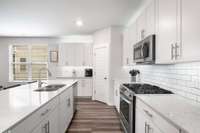 Shot of the gas stove, all appliances stainless steel.