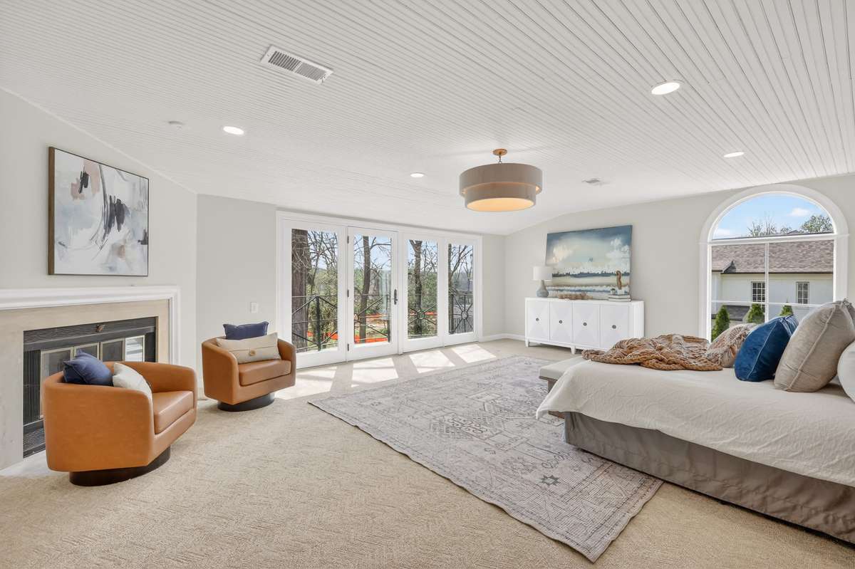 Upstairs primary with fire place and balcony