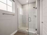 Large tiled shower with frameless glass