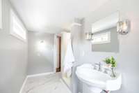 Sleek tile flooring adds durability and style, complementing the clean and timeless design