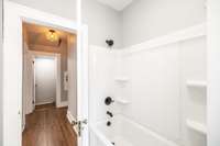 The tub-shower combination in the main level bath with clean fresh look offers both style and functionality.