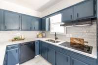 A closer look at the painted cabinets and hardware, showing the careful balance of modern style and historic character