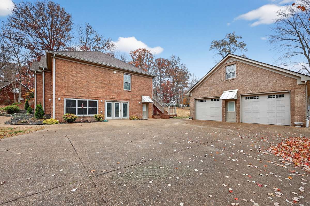 Notice the size of garage doors. and the upstairs window allowing plenty of natural light to the unfinished area upstairs.  Also this is private ground level entrance to downstairs living space  Every detail thought of in this home