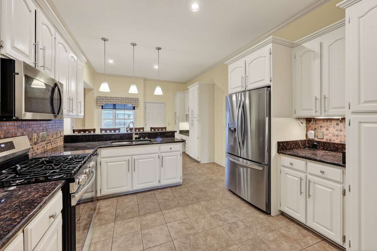 Another view of kitchen showing stainless appliances.   Gas Stove