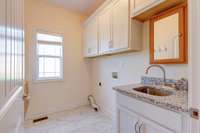 Laundry ROOM with Cabinetry, Sink, Tile Flooring, and folding table