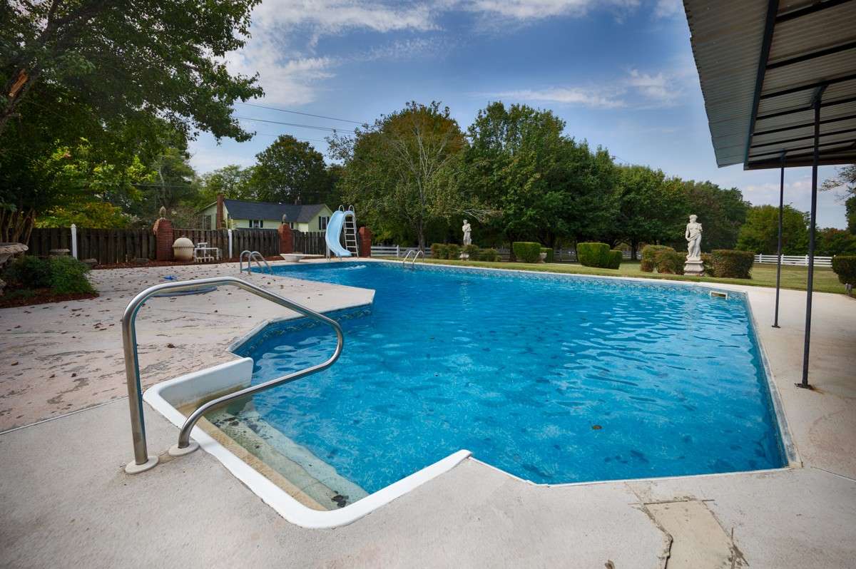Inground pool- two ladders in deep end, steps in shallow end, water slide