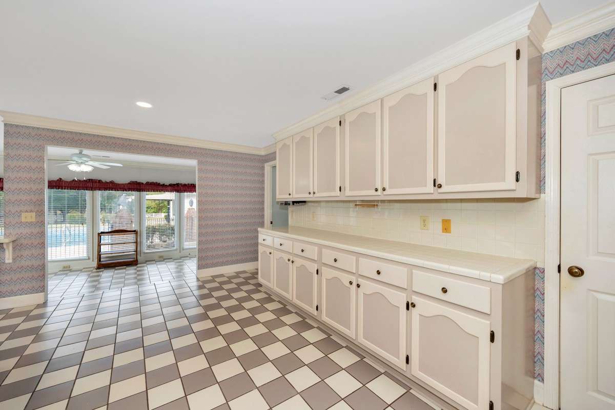 Kitchen- tile flooring, tile backsplash and countertops, crown molding
