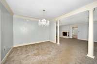 Dining Room- carpet, crown molding, columns