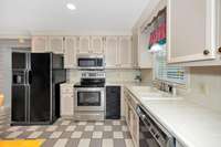 Kitchen- tile flooring, tile backsplash and countertops, crown molding