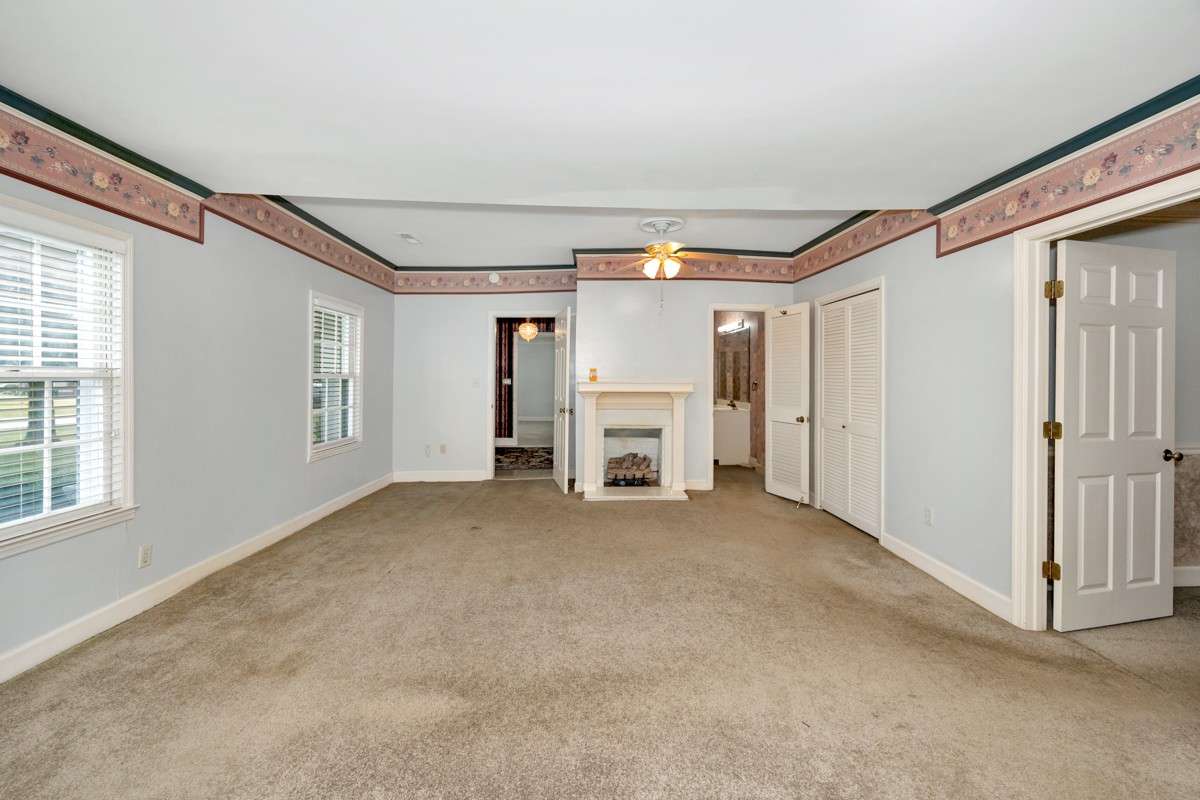 Bedroom- carpet, crown molding, gas fireplace, ceiling fan