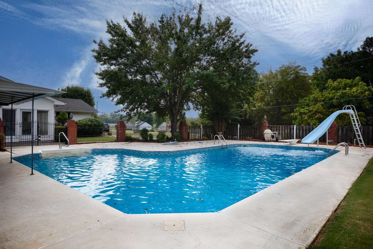 Inground pool- two ladders in deep end, steps in shallow end, water slide