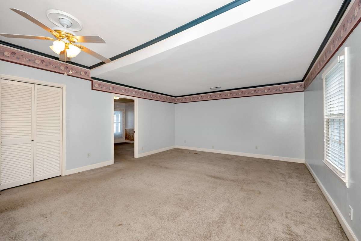 Bedroom- carpet, crown molding, gas fireplace, ceiling fan