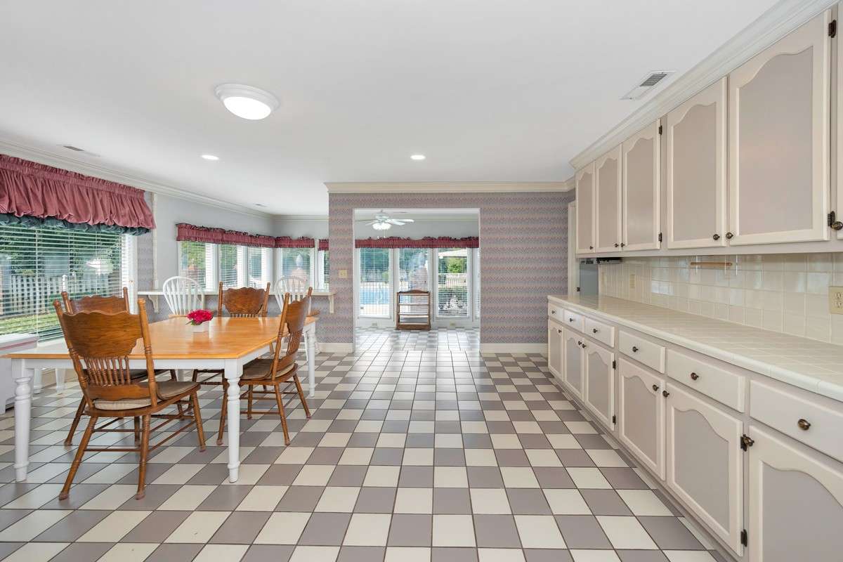 Kitchen- tile flooring, tile backsplash and countertops, crown molding
