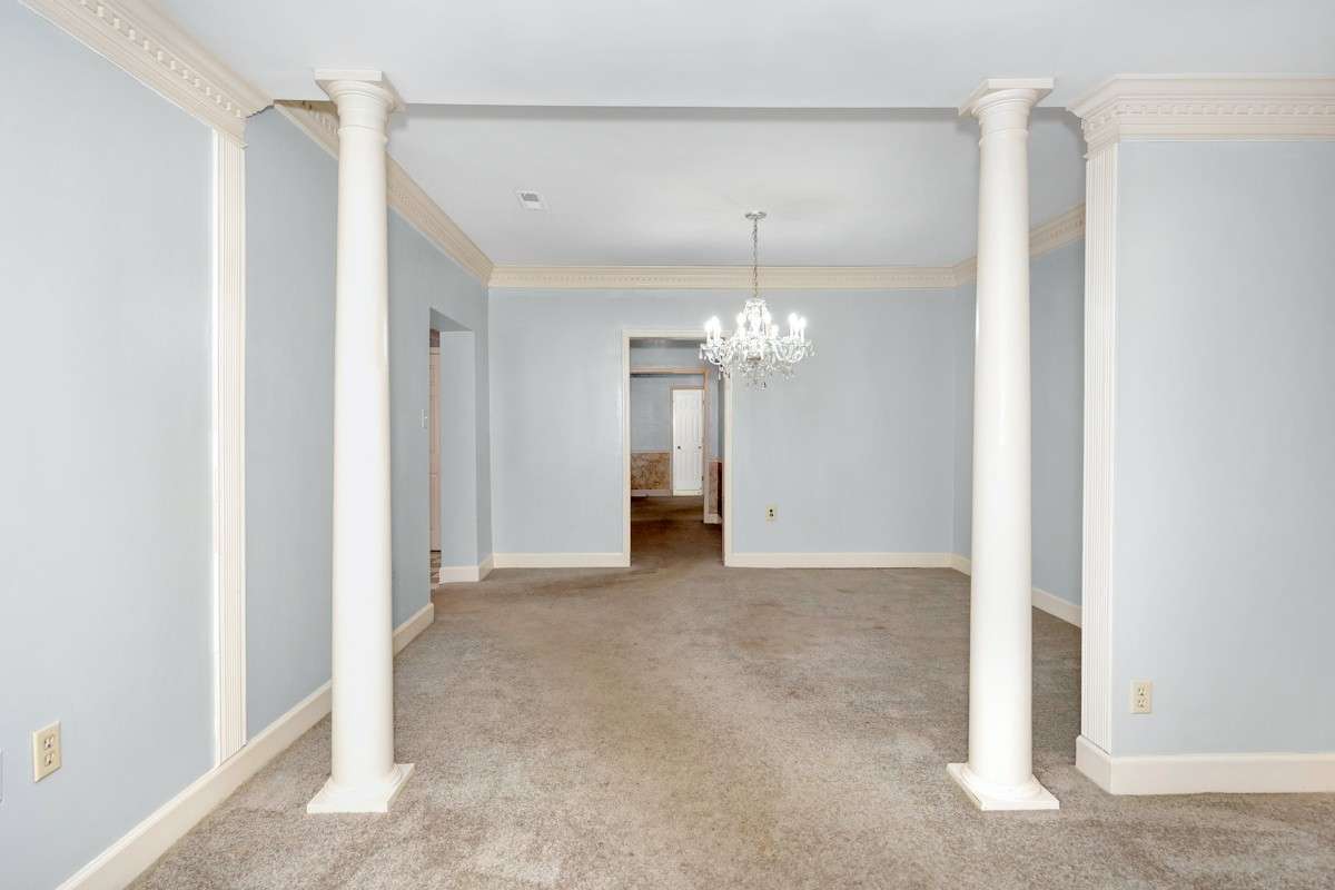 Dining Room- carpet, crown molding, columns