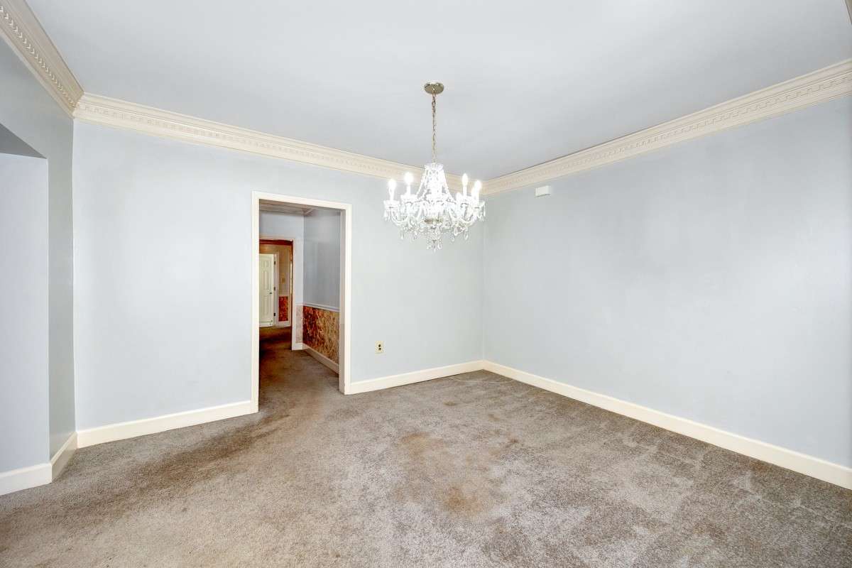 Dining Room- carpet, crown molding, columns