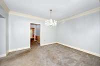 Dining Room- carpet, crown molding, columns