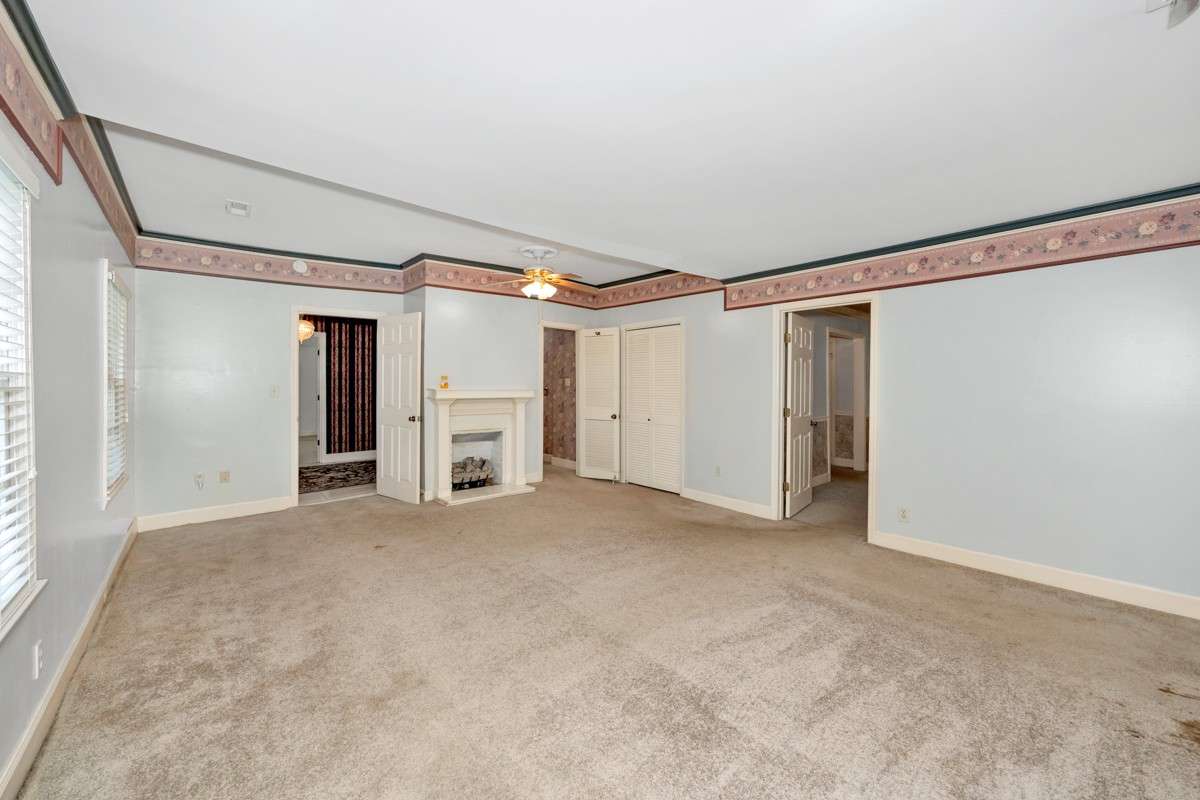 Bedroom- carpet, crown molding, gas fireplace, ceiling fan